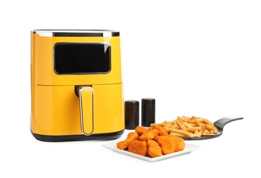 Photo of Modern air fryer and cooked meals isolated on white