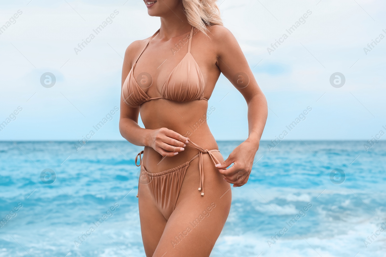 Photo of Woman wearing stylish bikini on beach, closeup