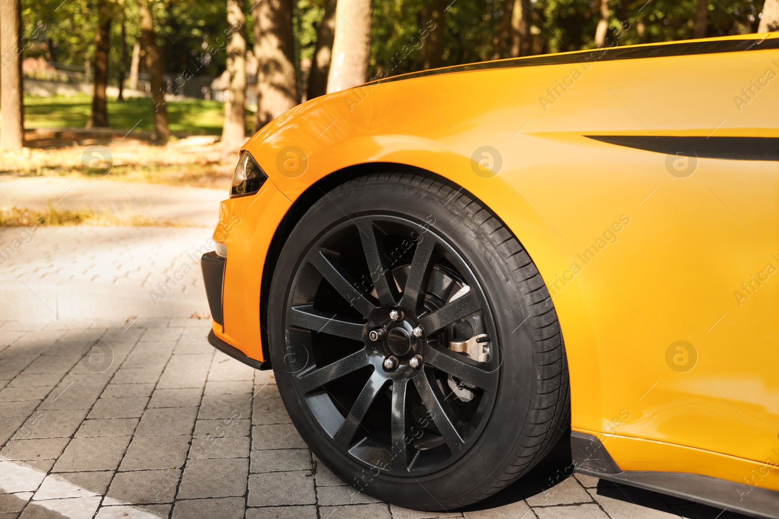 Photo of Modern cabriolet parked on parking lot outdoors, closeup