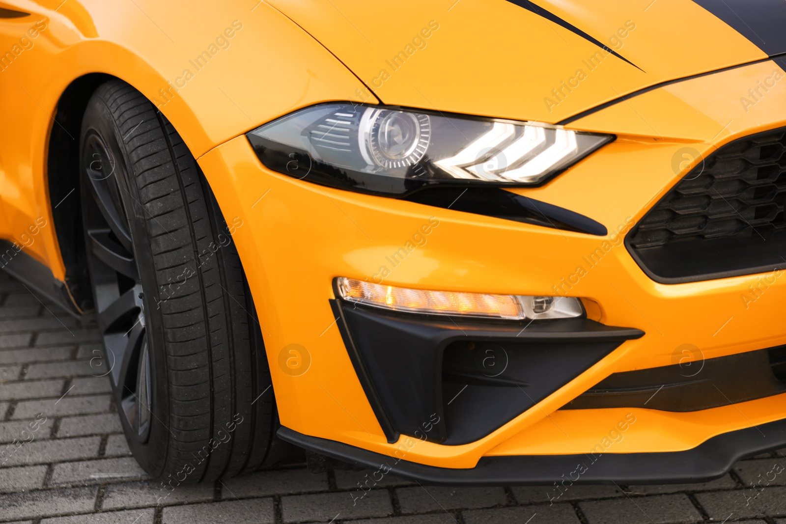 Photo of Modern cabriolet parked on parking lot outdoors, closeup