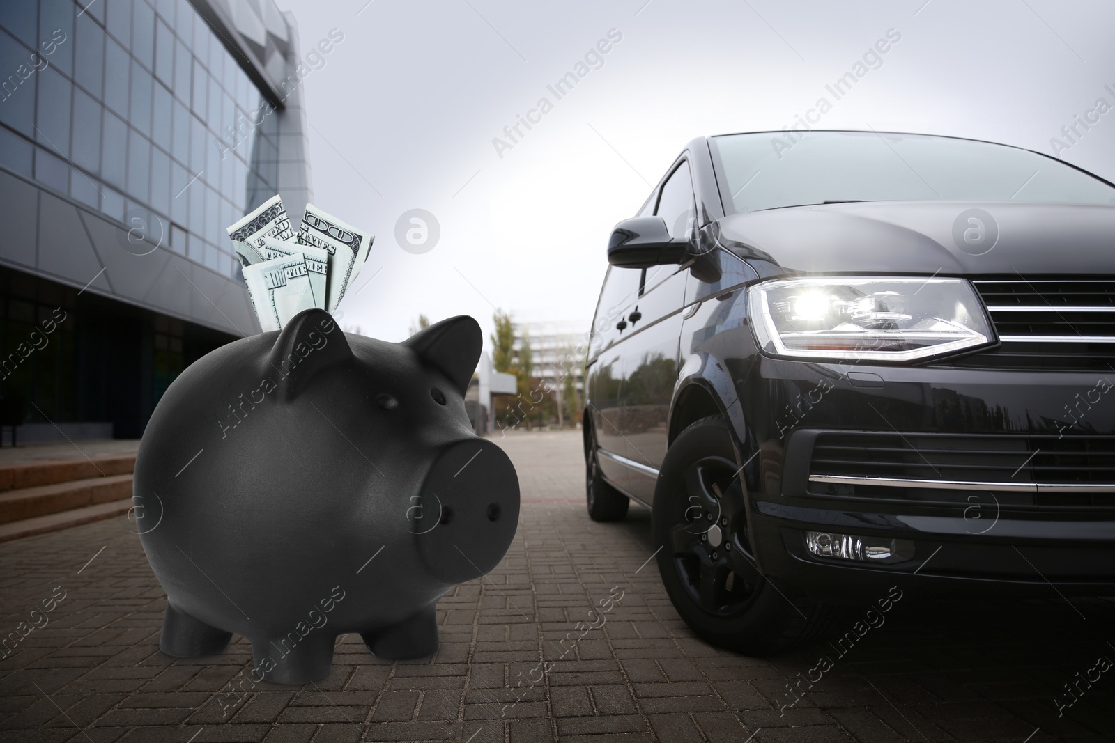 Image of Save money for car. Black piggy bank with dollars near automobile outdoors