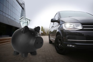 Image of Save money for car. Black piggy bank with dollars near automobile outdoors