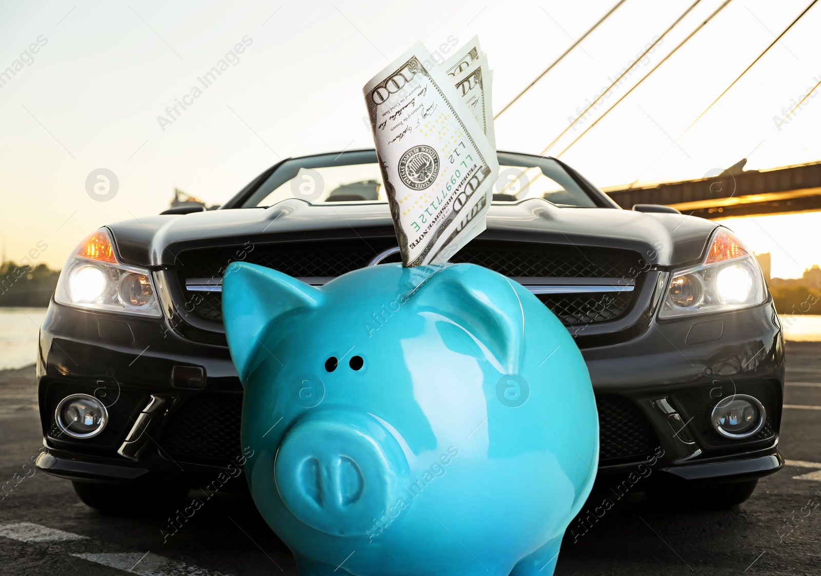 Image of Save money for car. Blue piggy bank with dollars against automobile