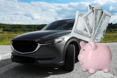 Image of Save money for car. Pink piggy bank with dollars near automobile outdoors