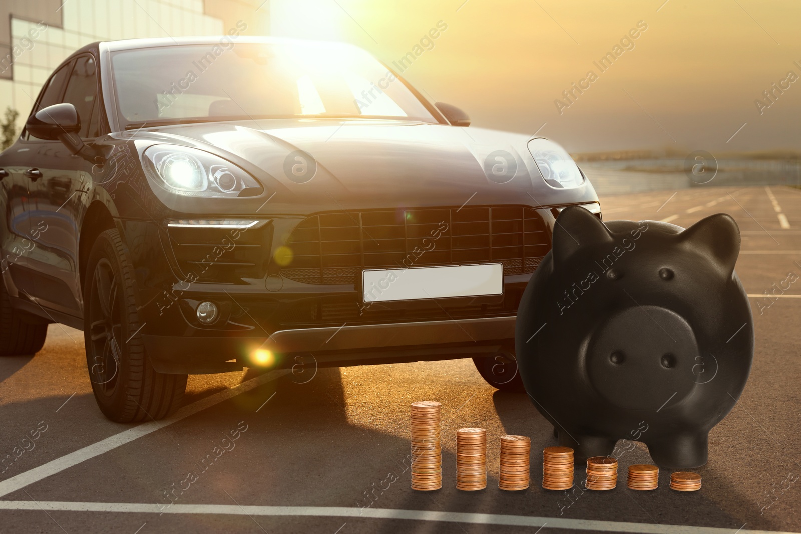 Image of Save money for car. Black piggy bank and coins near automobile outdoors