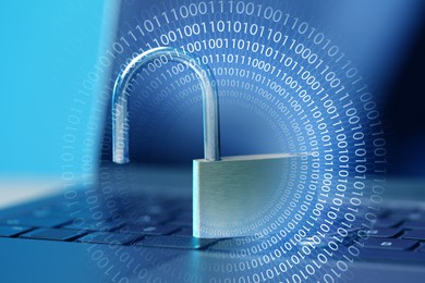 Image of Open padlock on laptop, toned in blue. Binary code. Cyber security