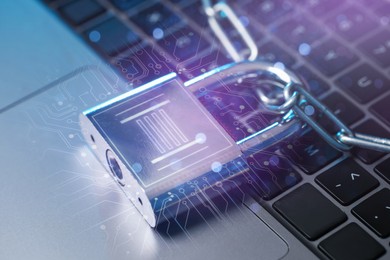 Image of Padlock with digital fingerprint scan and chain on laptop. Circuit board pattern. Cyber security