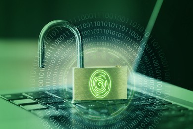 Image of Open padlock with digital fingerprint scan on laptop, toned in green. Binary code. Cyber security