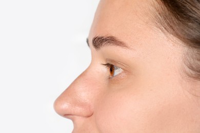 Photo of Woman with beautiful eyes on light background, closeup. Space for text