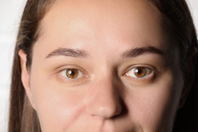 Photo of Woman with beautiful eyes on light background, closeup