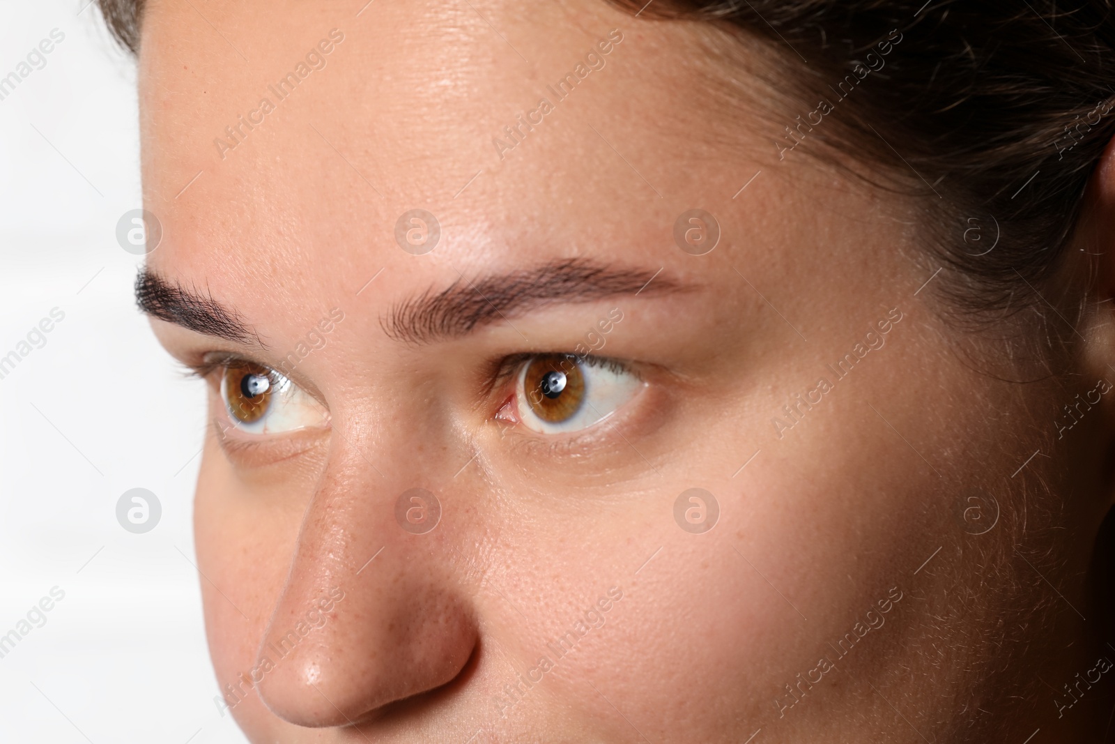 Photo of Woman with beautiful eyes on light background, closeup