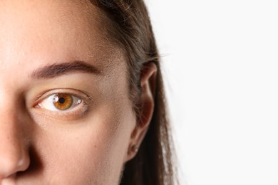 Photo of Woman with beautiful eyes on light background, closeup. Space for text