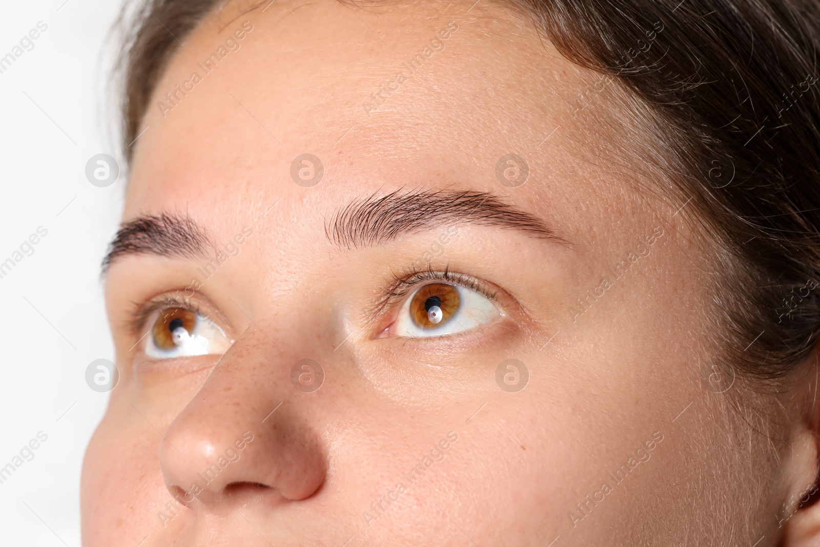 Photo of Woman with beautiful eyes on light background, closeup