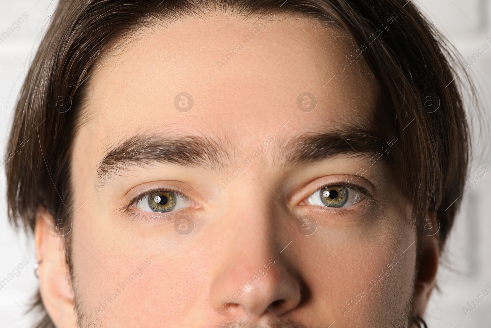 Photo of Man with beautiful eyes on light background, closeup