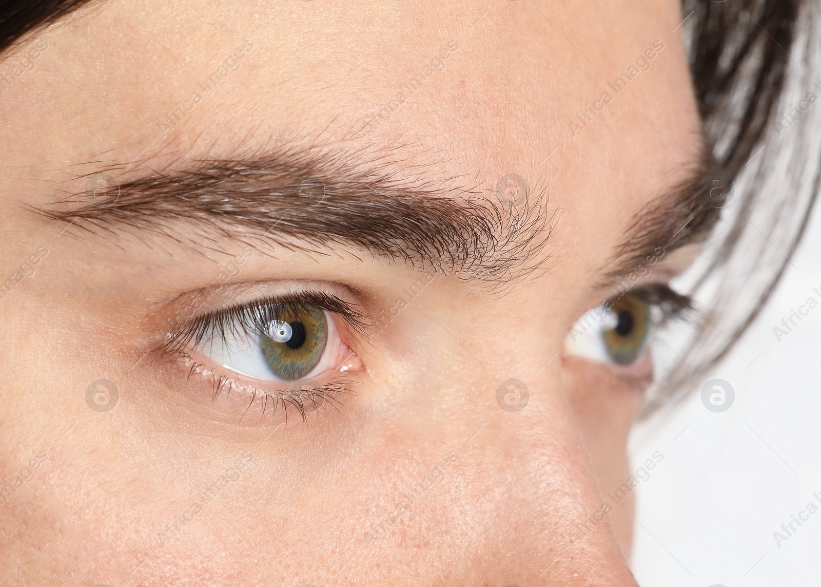 Photo of Man with beautiful eyes on light background, closeup