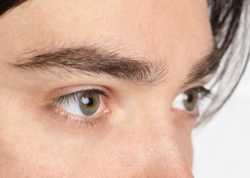 Photo of Man with beautiful eyes on light background, closeup