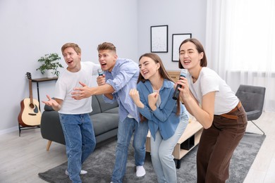 Photo of Group of friends singing karaoke at home