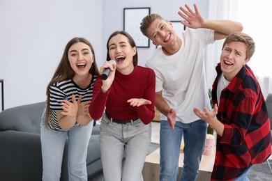 Photo of Group of friends singing karaoke at home