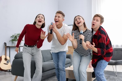 Photo of Group of friends singing karaoke at home