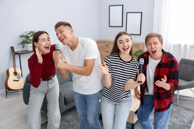 Photo of Group of friends singing karaoke at home