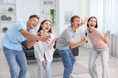 Photo of Group of friends singing karaoke at home