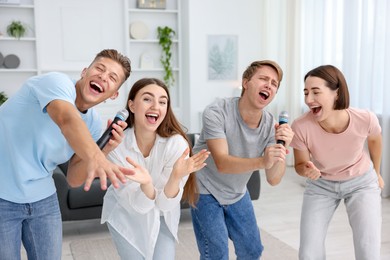 Photo of Group of friends singing karaoke at home