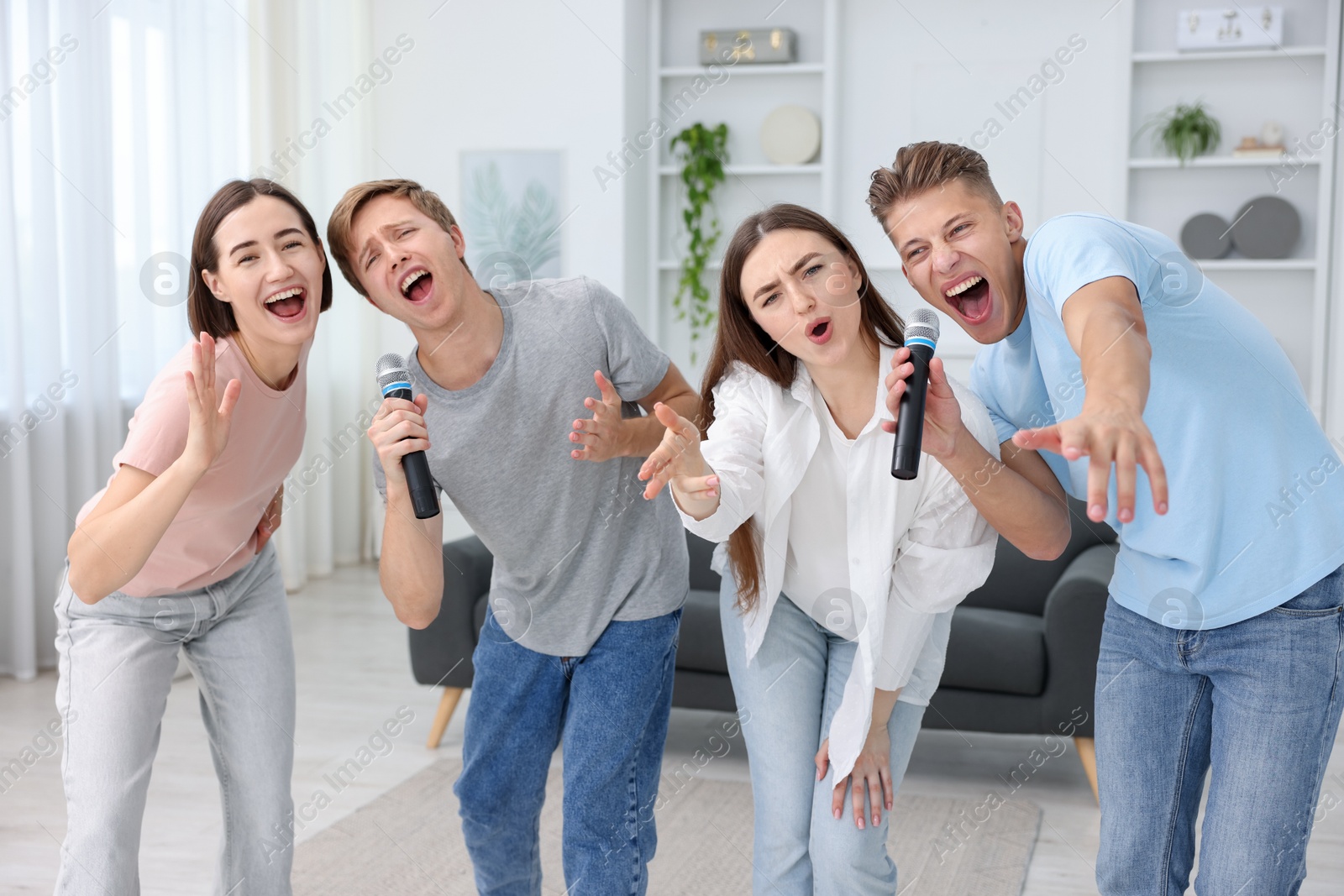 Photo of Group of friends singing karaoke at home