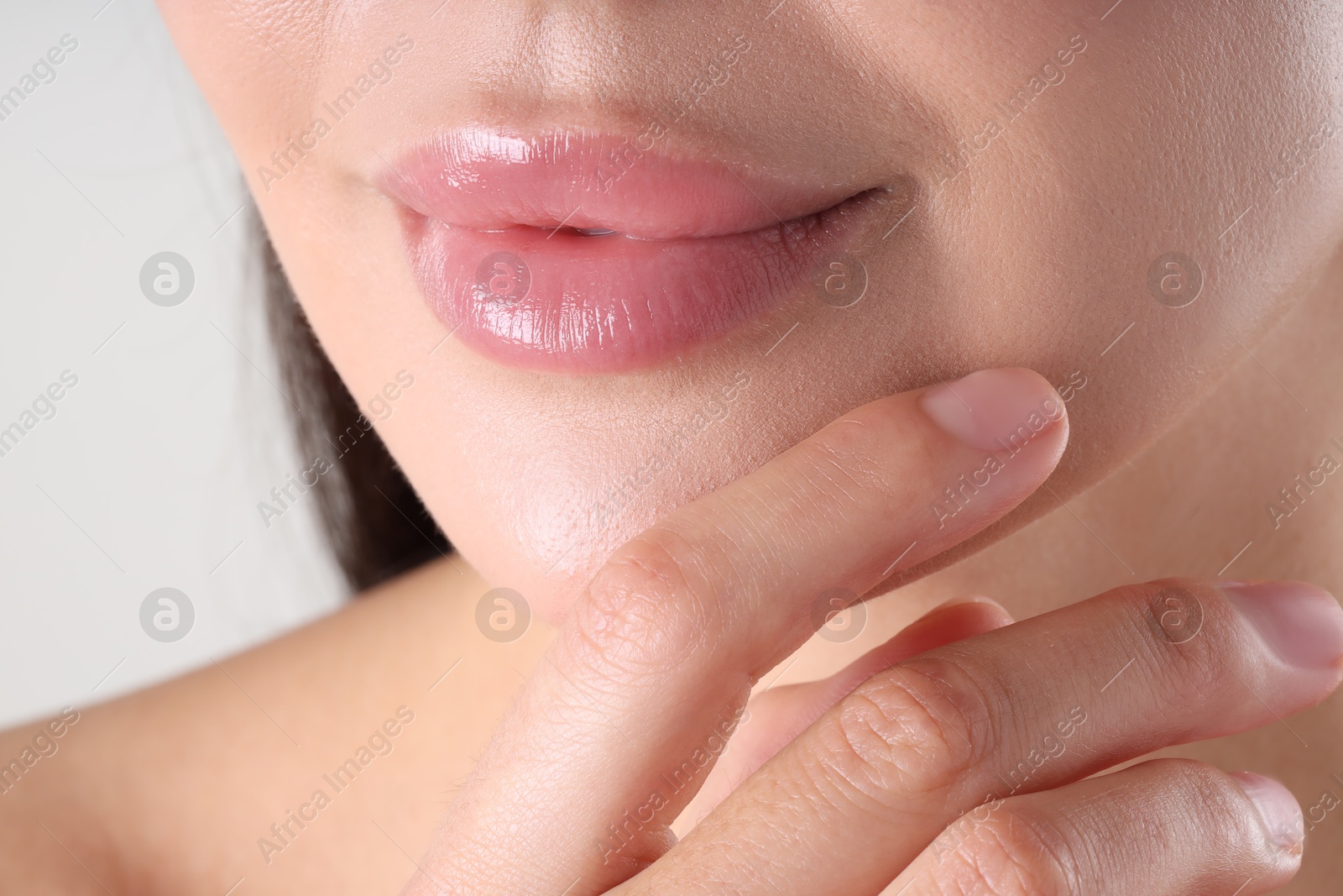 Photo of Woman with beautiful lips on light grey background, macro view
