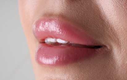 Photo of Woman with beautiful lips on light grey background, macro view