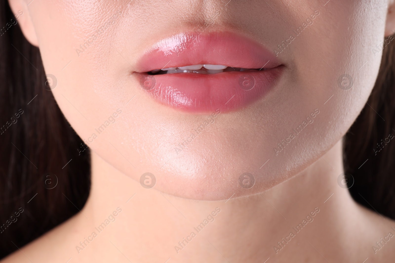 Photo of Woman with beautiful lipgloss on her lips , macro view