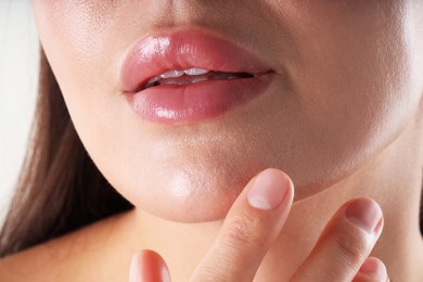 Photo of Woman with beautiful lips on white background, closeup