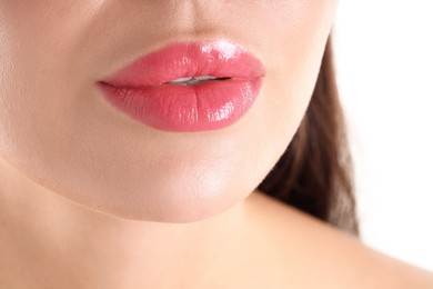Photo of Woman with beautiful pink lipstick on her lips against white background, closeup