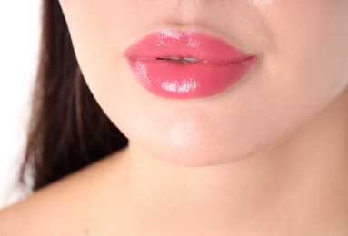 Photo of Woman with beautiful pink lipstick on her lips against white background, closeup
