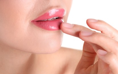 Photo of Woman with beautiful pink lipstick on her lips against white background, closeup