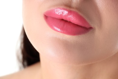 Photo of Woman with beautiful pink lipstick on her lips against white background, closeup