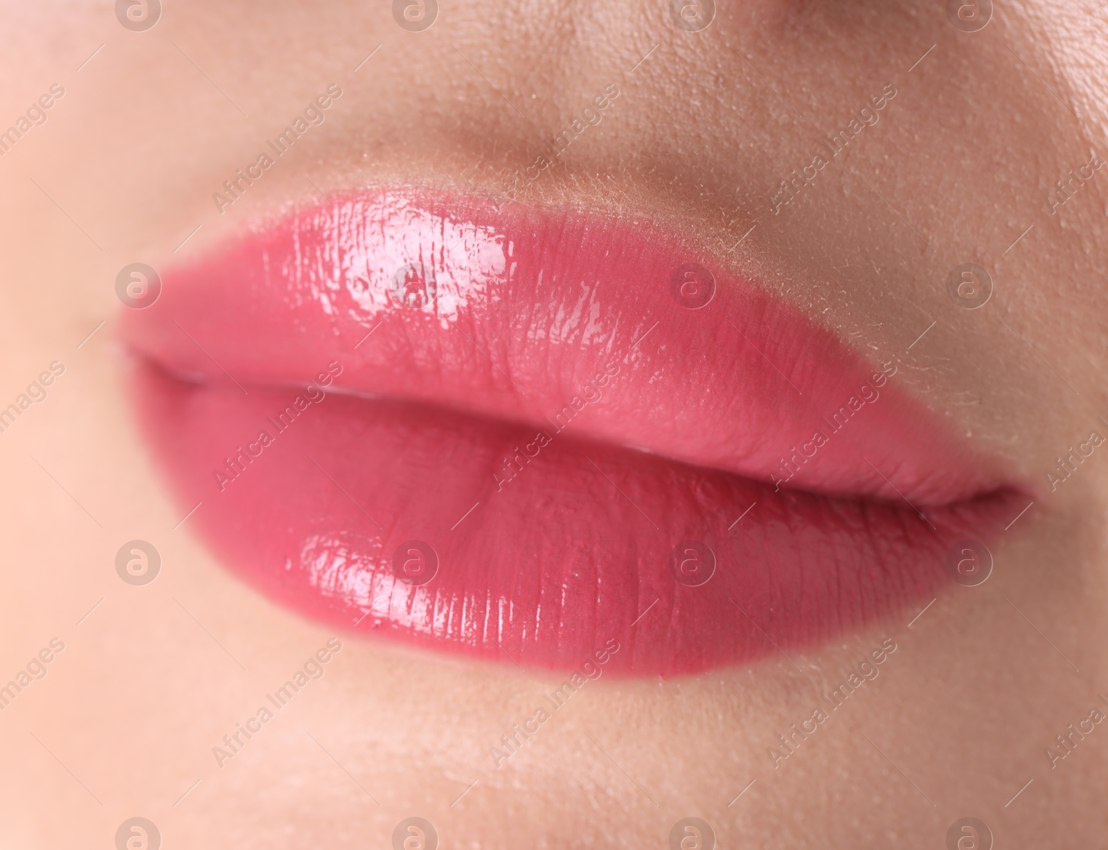 Photo of Woman with beautiful pink lipstick on her lips against white background, closeup