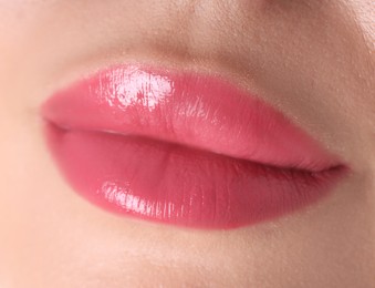 Photo of Woman with beautiful pink lipstick on her lips against white background, closeup