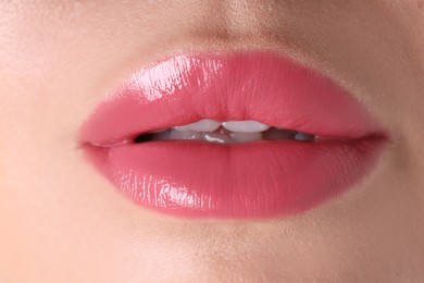 Photo of Woman with beautiful pink lipstick on her lips, macro view