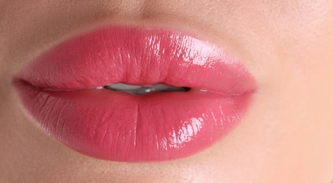 Photo of Woman with beautiful pink lipstick on her lips, macro view