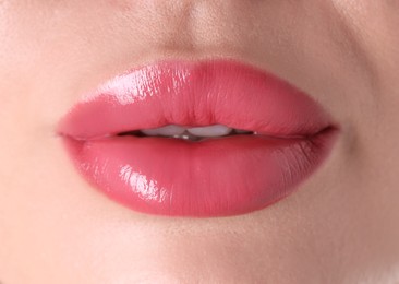 Photo of Woman with beautiful pink lipstick on her lips, macro view