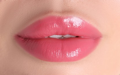 Photo of Woman with beautiful pink lipstick on her lips, macro view