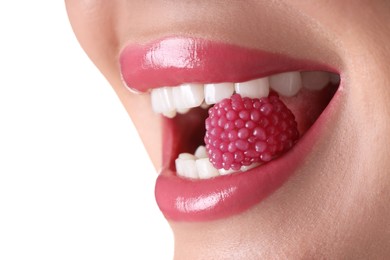 Photo of Woman with beautiful pink lipstick on her lips and raspberry candy against white background, closeup