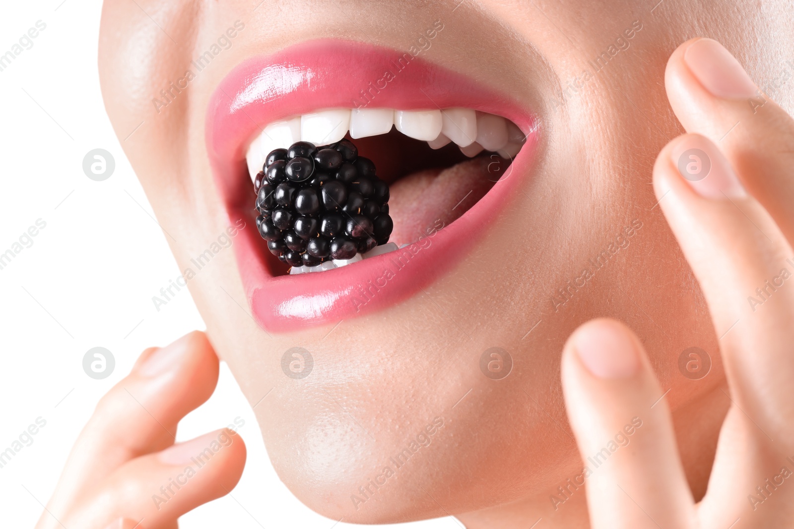 Photo of Woman with beautiful pink lipstick on her lips and blackberry against white background, closeup