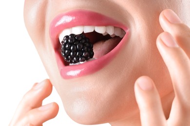 Photo of Woman with beautiful pink lipstick on her lips and blackberry against white background, closeup