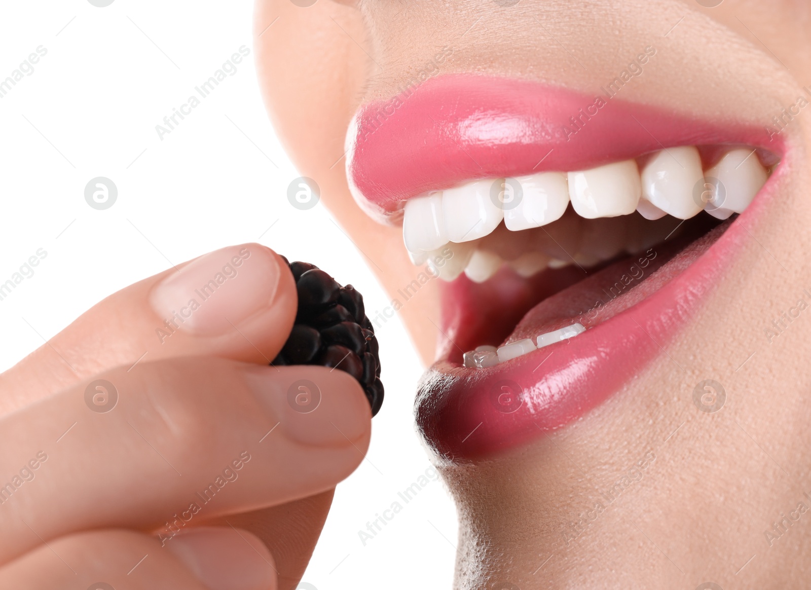Photo of Woman with beautiful pink lipstick on her lips and blackberry against white background, closeup