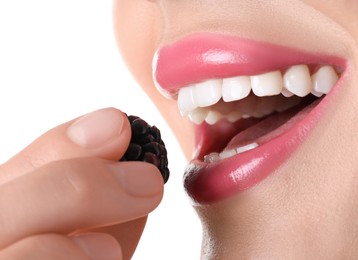 Photo of Woman with beautiful pink lipstick on her lips and blackberry against white background, closeup