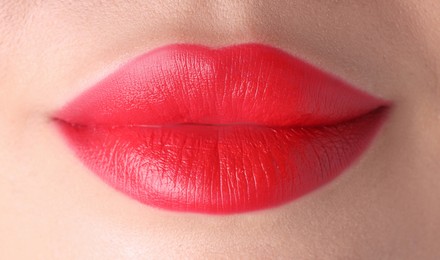 Photo of Woman with beautiful red lipstick on her lips, macro view
