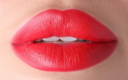 Photo of Woman with beautiful red lipstick on her lips, macro view
