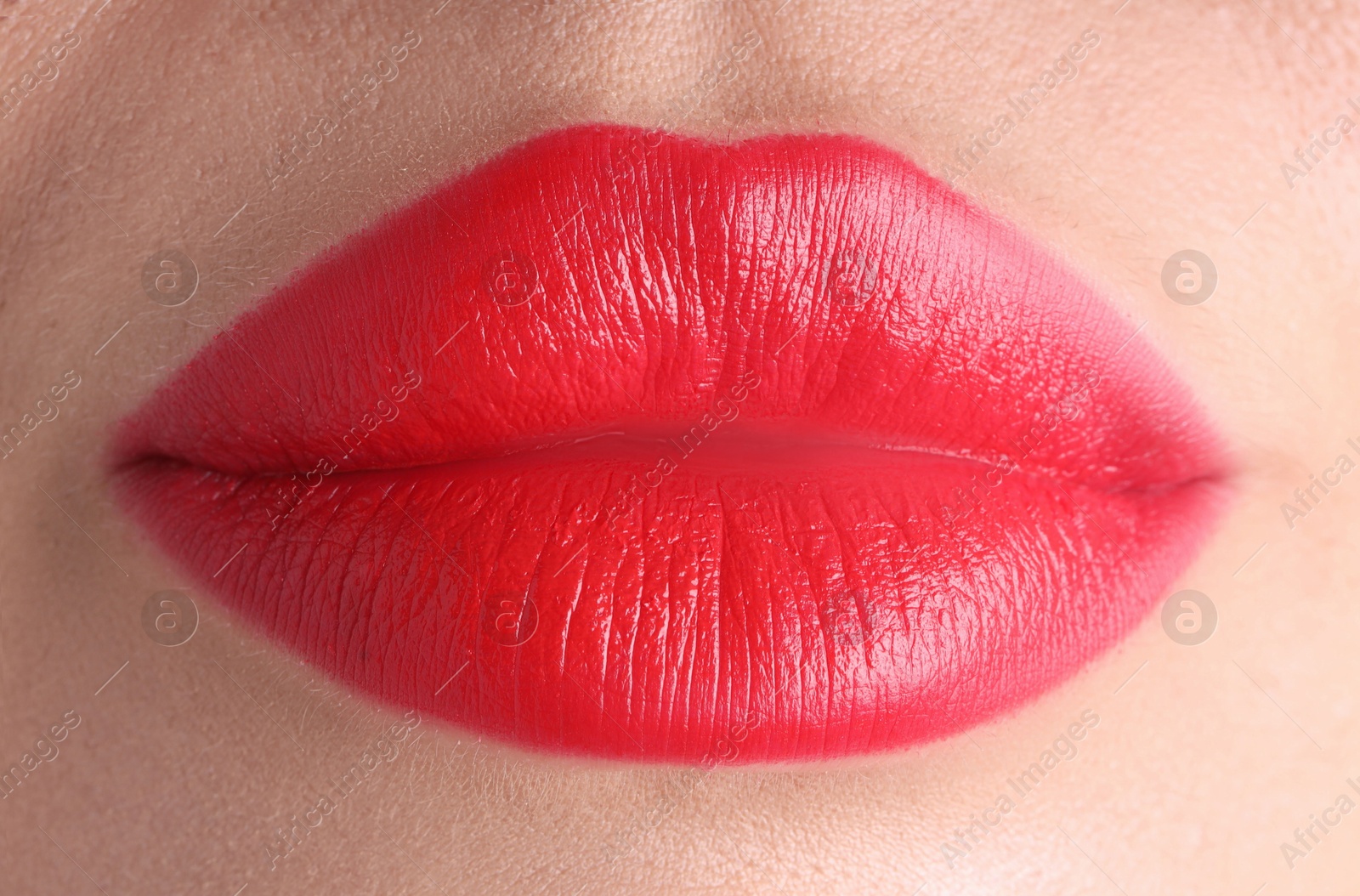 Photo of Woman with beautiful red lipstick on her lips, macro view