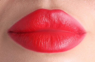 Photo of Woman with beautiful red lipstick on her lips, macro view